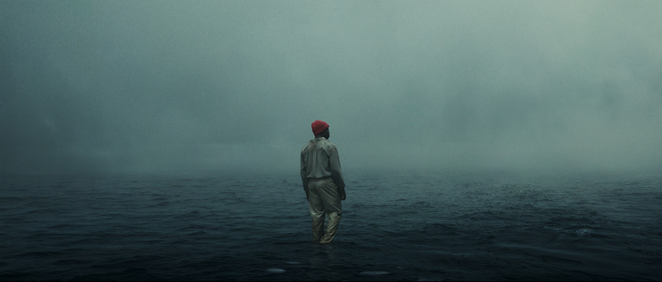 Concept art for the Netflix film His House, showing a surreal scene of a man standing in a stormy blue moody ocean